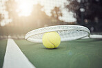 Closeup view of a tennis ball and tennis racket on a court in a sports club during the day. Playing tennis is exercise, promotes health, wellness and fitness. Macro view of tennis gear and equipment
