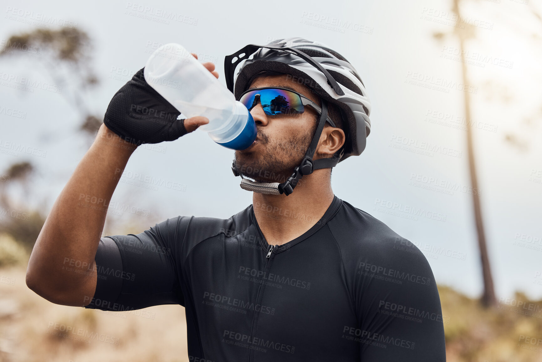 Buy stock photo Man, break and drinking water with bottle while cycling for fitness, health and french sports competition. Cyclist, tired and hydration with clear liquid as athlete for race, performance and wellness