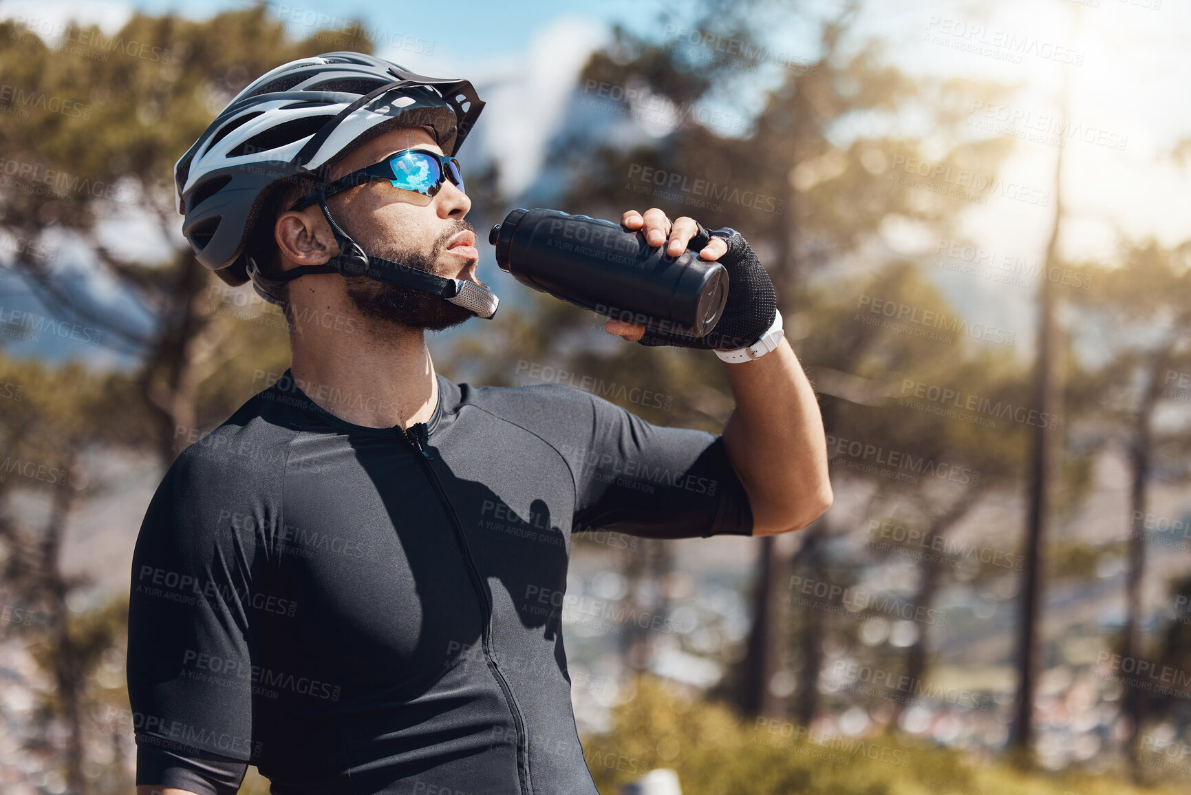 Buy stock photo Man, tired and drinking water with bottle while cycling for fitness, health and french sports competition. Cyclist, break and hydration with clear liquid as athlete for race, performance and wellness