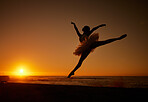 Silhouette of a ballet dancer in tutu dancing on the beach at sunset. Graceful ballerina dancing and jumping outdoors