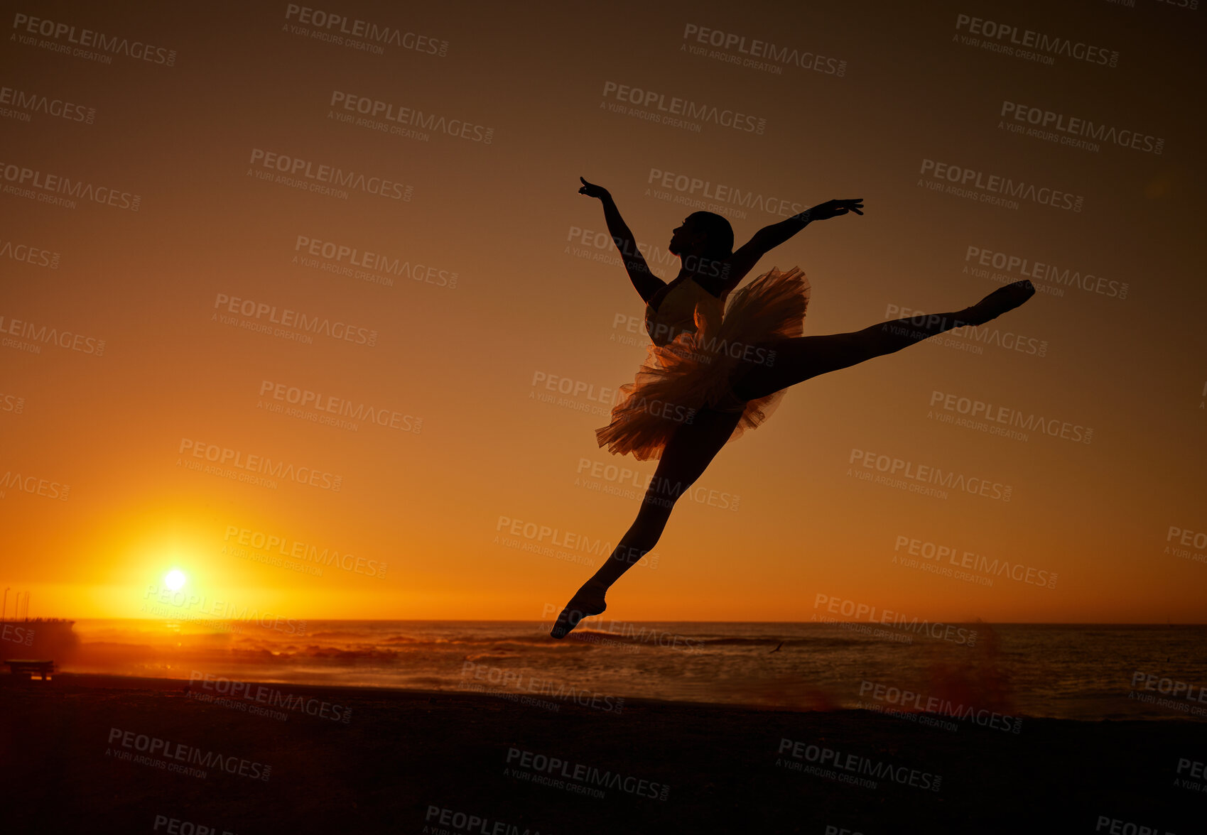 Buy stock photo Ballet, sunset and silhouette at beach for jump, creative and freedom with energy, water and balance. Ballerina, person and fitness outdoor by ocean for aesthetic, performance and exercise as dance