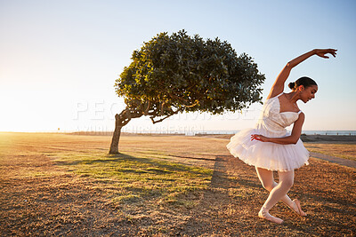 Buy stock photo Ballet, tree and woman in nature for dance, creative and freedom with energy, park and balance. Ballerina, garden and fitness outdoor by field for aesthetic, performance and exercise as artist