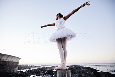 Buy stock photo Girl, ballet and stretching at beach for dance for freedom, peace and creative performance with balance. Woman, ballerina and moving outdoor at ocean for aesthetic, fitness or training with low angle