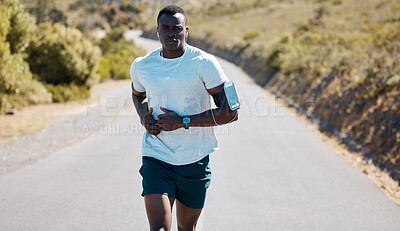 Buy stock photo Black man, health and running with earphones on road for music, workout or outdoor cardio in nature. Active African, runner or male person in sprint or fitness with audio on street for exercise