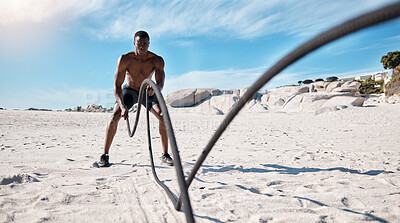 Buy stock photo Fitness, man and battle rope at beach for power, grip strength or intense cardio exercise. Sports, athlete and black person with full body workout for performance, muscle endurance or arm training