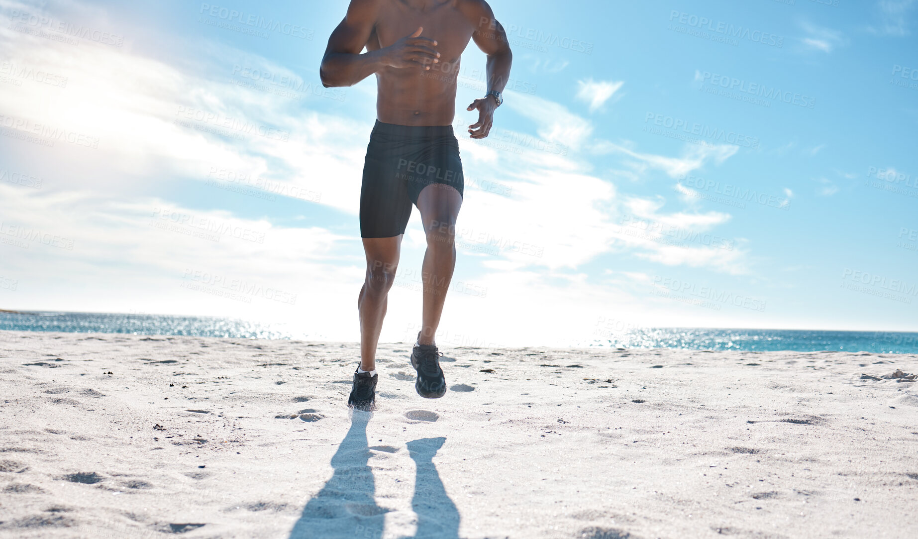 Buy stock photo Man, fitness and running on beach for exercise, workout and cardiovascular health outdoor. Athlete, jog and high intensity training by ocean with sand, sun and water for speed and performance