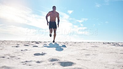 Buy stock photo Black man, training and running on beach for exercise, workout and cardiovascular health outdoor. Athlete, jog and high intensity fitness by ocean with sand, sun and sky for speed and low angle