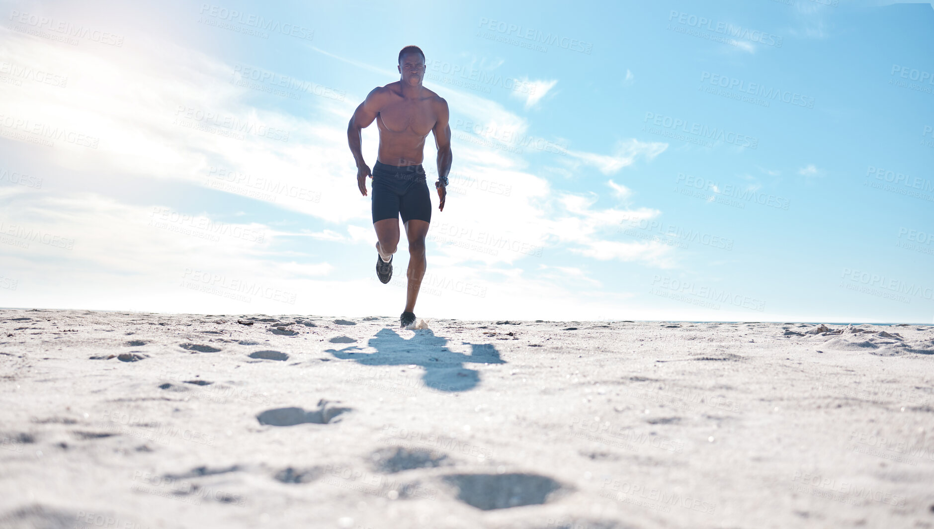 Buy stock photo Black man, training and running on beach for exercise, workout and cardiovascular health outdoor. Athlete, jog and high intensity fitness by ocean with sand, sun and sky for speed and low angle