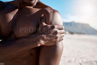 Buy stock photo Fitness, shoulder pain and man on beach with injury for arm inflammation, muscle strain or ache. Suffering, body and hand of athlete with discomfort for sprain, emergency or exercise accident