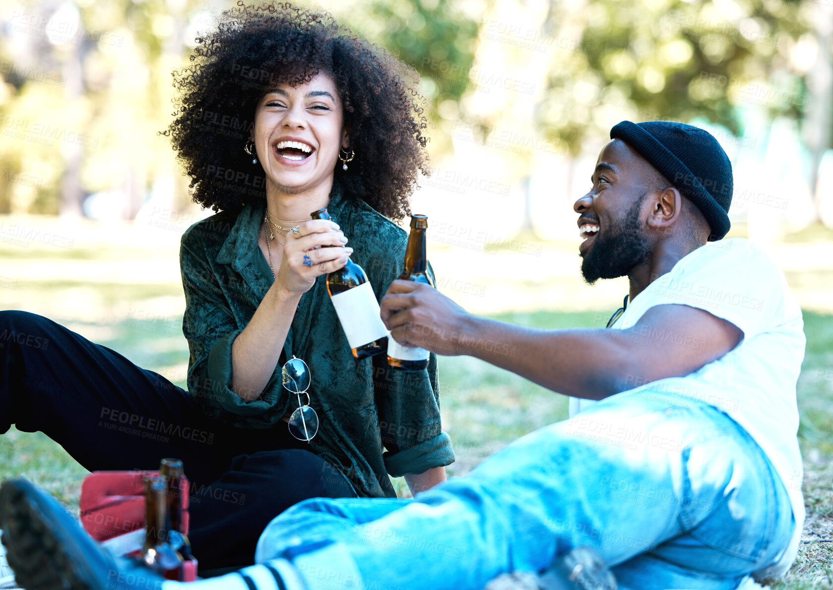 Buy stock photo Wine bottle, celebration and couple having a picnic date at the park or on a field with nature bokeh. Young and excited black man and woman or people with alcohol drink and enjoying outdoor together