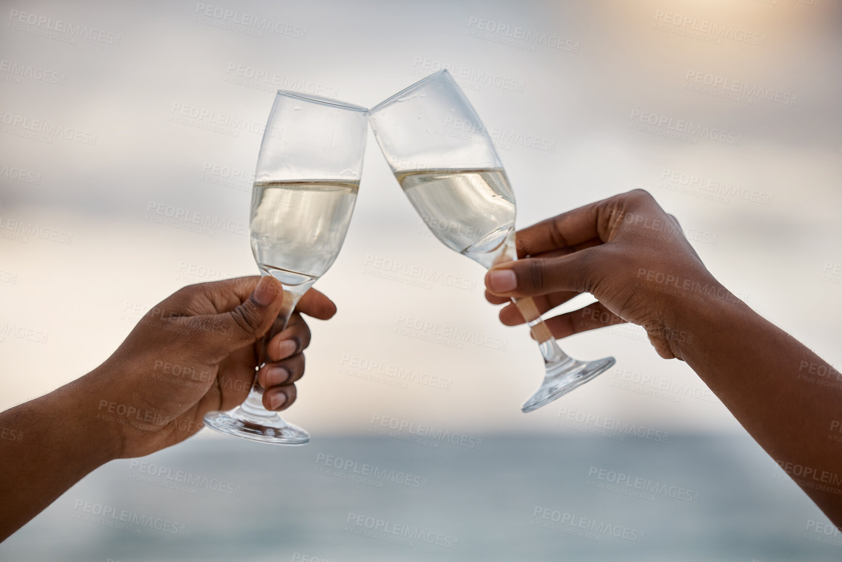 Buy stock photo Sunset, couple and hands toast with wine glass, having fun or celebrating together for anniversary. Vacation, champagne and people cheers with alcohol drink for marriage on holiday, summer and beach