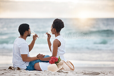 Buy stock photo Black couple, drink and relax outdoor by beach for romantic date on vacation, anniversary getaway and bonding. Man, woman and together with white wine, ocean escape and commitment for love connection