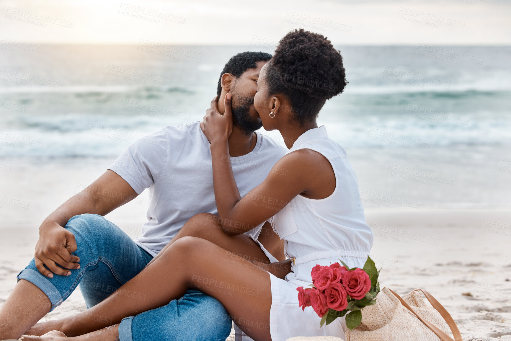 Buy stock photo Sunset, black couple and kiss with picnic, having fun or celebrating together for anniversary. Vacation, honeymoon and people with romance, travel and marriage on summer holiday and Miami beach