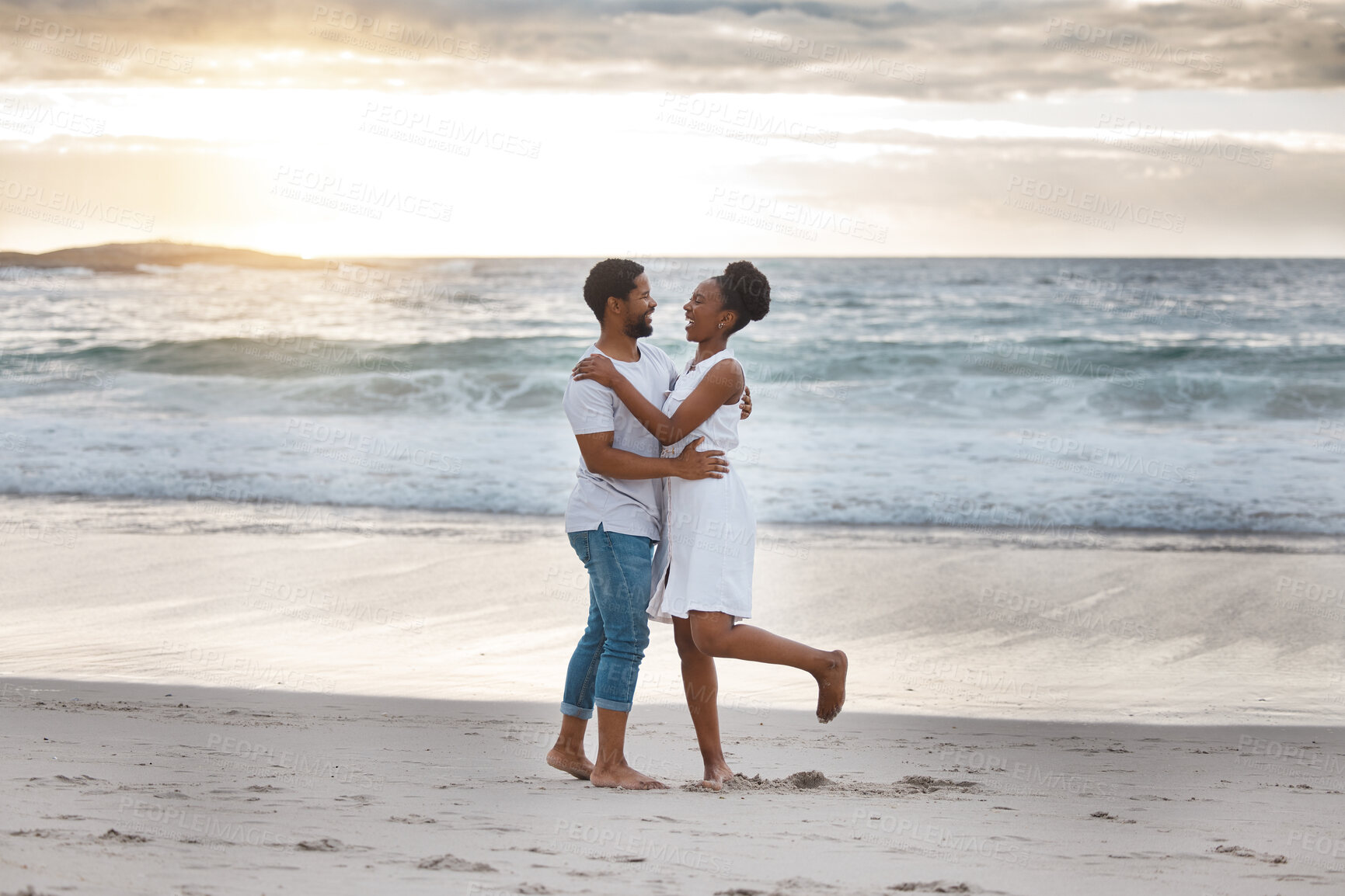 Buy stock photo Sunset, black couple and hug with beach trip, having fun or celebrating together for anniversary. Vacation, honeymoon and people with romance, travel and marriage on summer holiday and Miami ocean