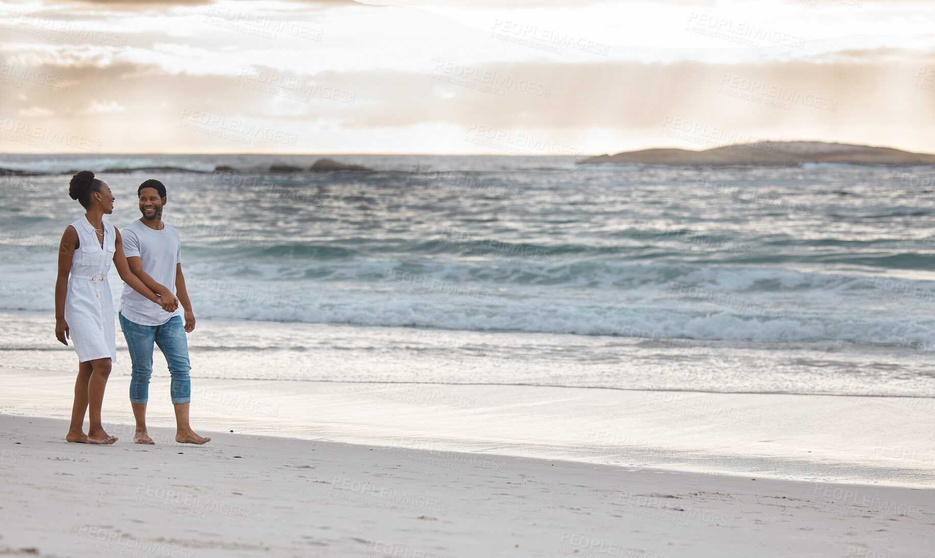 Buy stock photo Couple, walking and sunset at beach for holiday, travel and date in summer while bonding together. Man, woman and holding hands by ocean for vacation, love and freedom with romance, water and sand