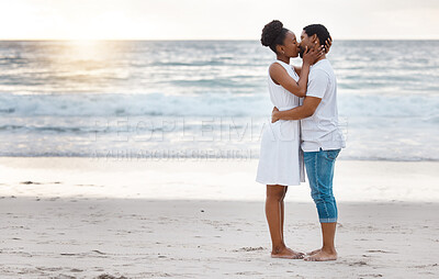 Buy stock photo Sunset, black couple and kiss with romance, beach and celebrating together for anniversary. Vacation, honeymoon and people relax with love, travel and marriage on summer holiday and Miami ocean