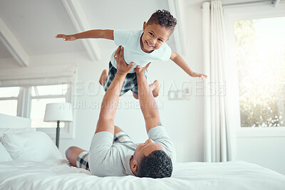 Buy stock photo Dad, boy and happy with flying in bed at home for fun to relax, bonding and care in Brazil. People, parent and kid in bedroom with playing for support, child development and childhood memories