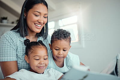 Buy stock photo Mom, kids and smile with storytelling in home for fun, bonding and care with education. Parent, family and happy for learning on book reading for knowledge, information and child development