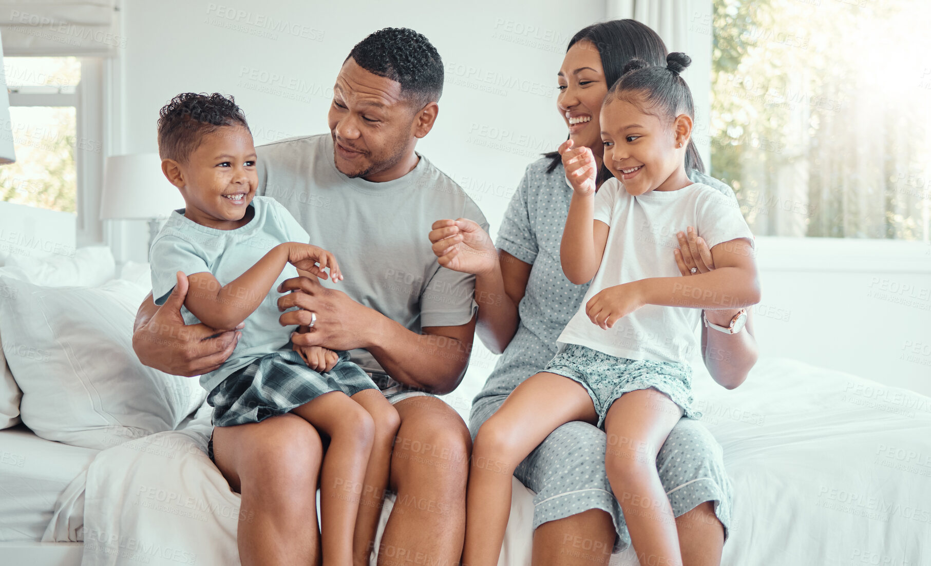 Buy stock photo Happy family, parents and tickle kids in bedroom for funny game, bonding or playing together in home. Morning, father and children laughing with mother for love, care and relax with siblings in house