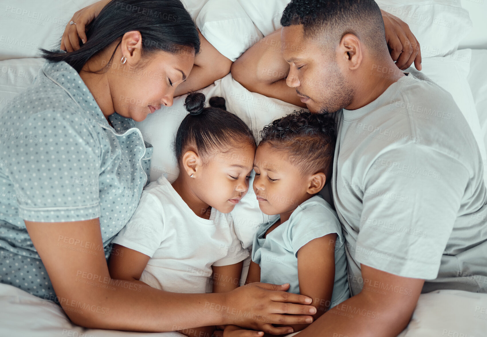 Buy stock photo Above, parents and children in bed sleeping at home with comfort, dreaming and relax on break. People, family and love in bedroom with bonding or cuddling with love, support and care or rest together