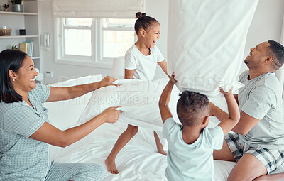 Buy stock photo Family, bedroom and pillow fight in home, happiness and game or bonding with children. Love, fun and people together in apartment with energy, smiling and weekend break in playful house with siblings