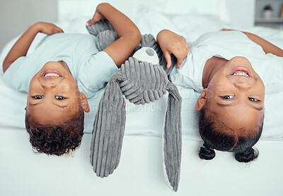 Buy stock photo Boy, girl and children with upside down portrait in bedroom for fun, growth and development on weekend in home. Siblings, family house and playful together with happiness, bonding and cheerful.