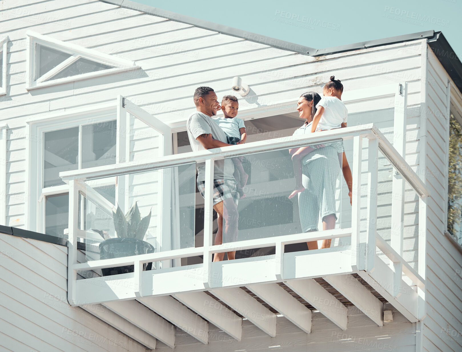 Buy stock photo Family, smile and parents with kids on balcony in morning for scenery, holiday accommodation or memories. People, travel and low angle in home on weekend trip for bonding, vacation and happy together