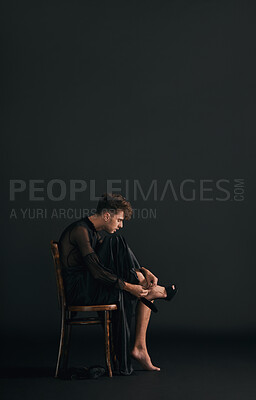 Buy stock photo Chair, man and fashion with high heels, queer and stylish clothes on dark studio background. Lgbtq community, gay and person with shoes, freedom or profile for comfort, pride or glamour with identity