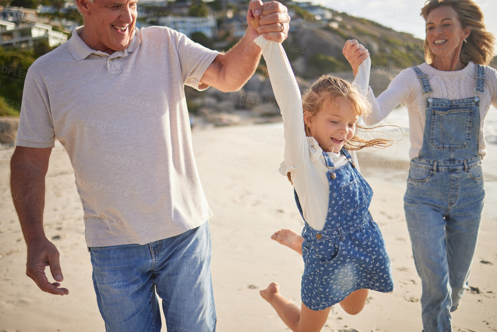 Buy stock photo Grandparents, girl and playing with walking in beach on break, trip and holiday in Australia. People, family and happy with kid for vacation, journey  and adventure in seaside for bonding and support