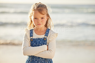 Buy stock photo Portrait, beach and girl with arms crossed, angry and upset with expression, emotion and vacation. Face, kid and child with emoji, frustrated and bored with adhd, tantrum and travel with autism