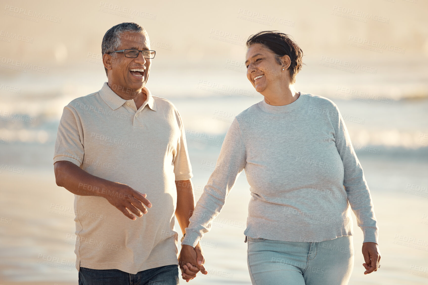 Buy stock photo Laugh, senior couple and holding hands at beach for date, holiday and summer vacation on island. Walking, man and woman at ocean together for romance, travel or funny conversation outdoor for love