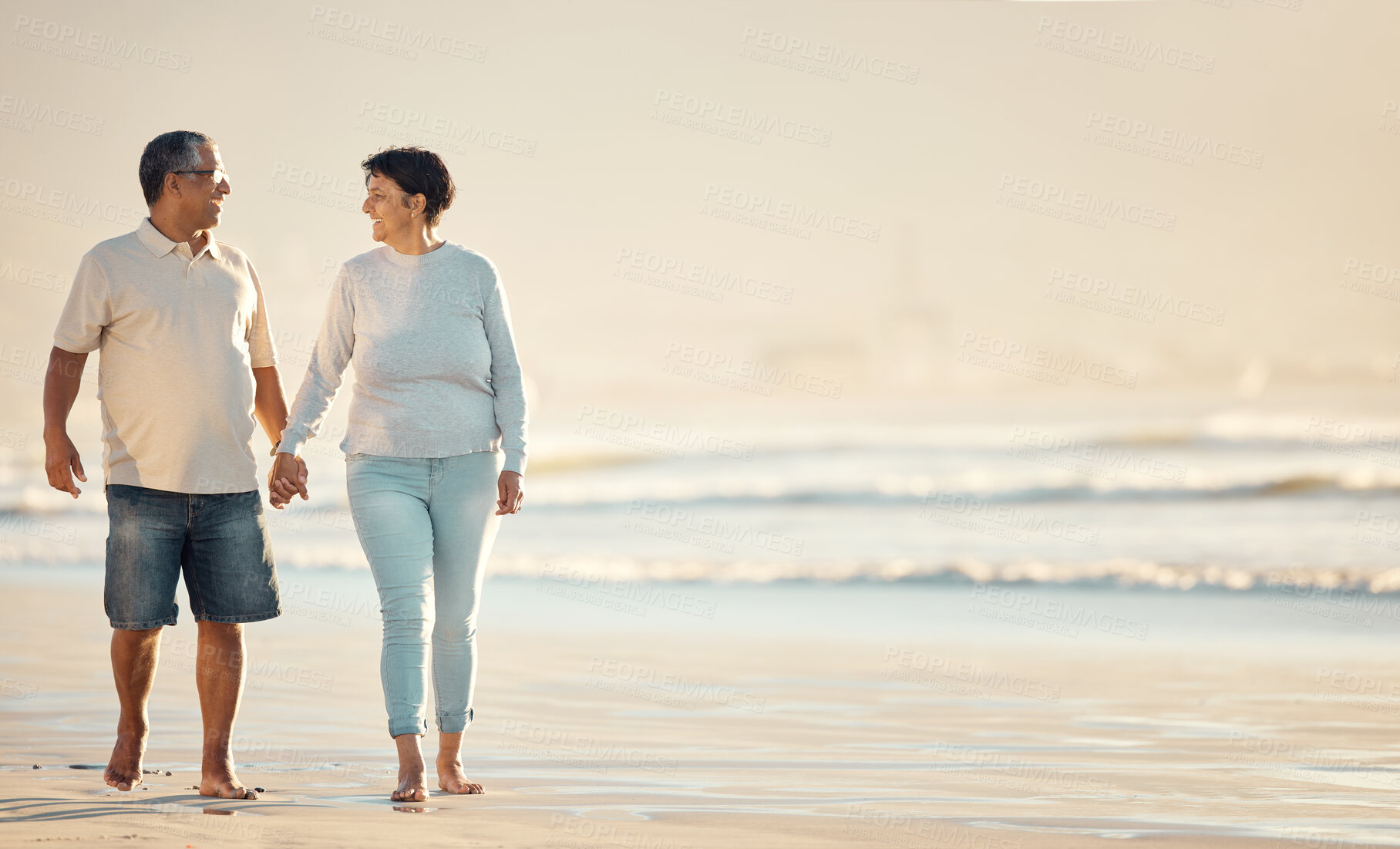 Buy stock photo Smile, senior couple and holding hands at beach for date, holiday and summer vacation on mockup space. Walk, man and woman at ocean together for romance, travel or funny conversation outdoor for love