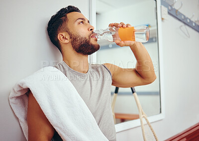 Buy stock photo Man, relax and drinking with bottle water for hydration, natural sustainability or break at gym locker room. Young male person in recovery or thirst with mineral beverage on bench at health club