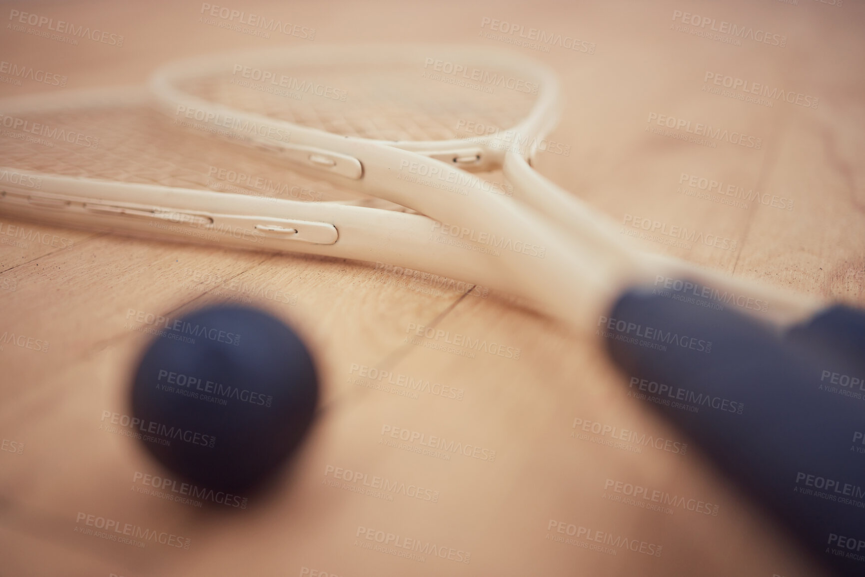 Buy stock photo Closeup, floor and racket with ball for squash, competition and match for professional athletics. Indoor sports, wooden surface and rubber with equipment for serving, grip tape and court for game