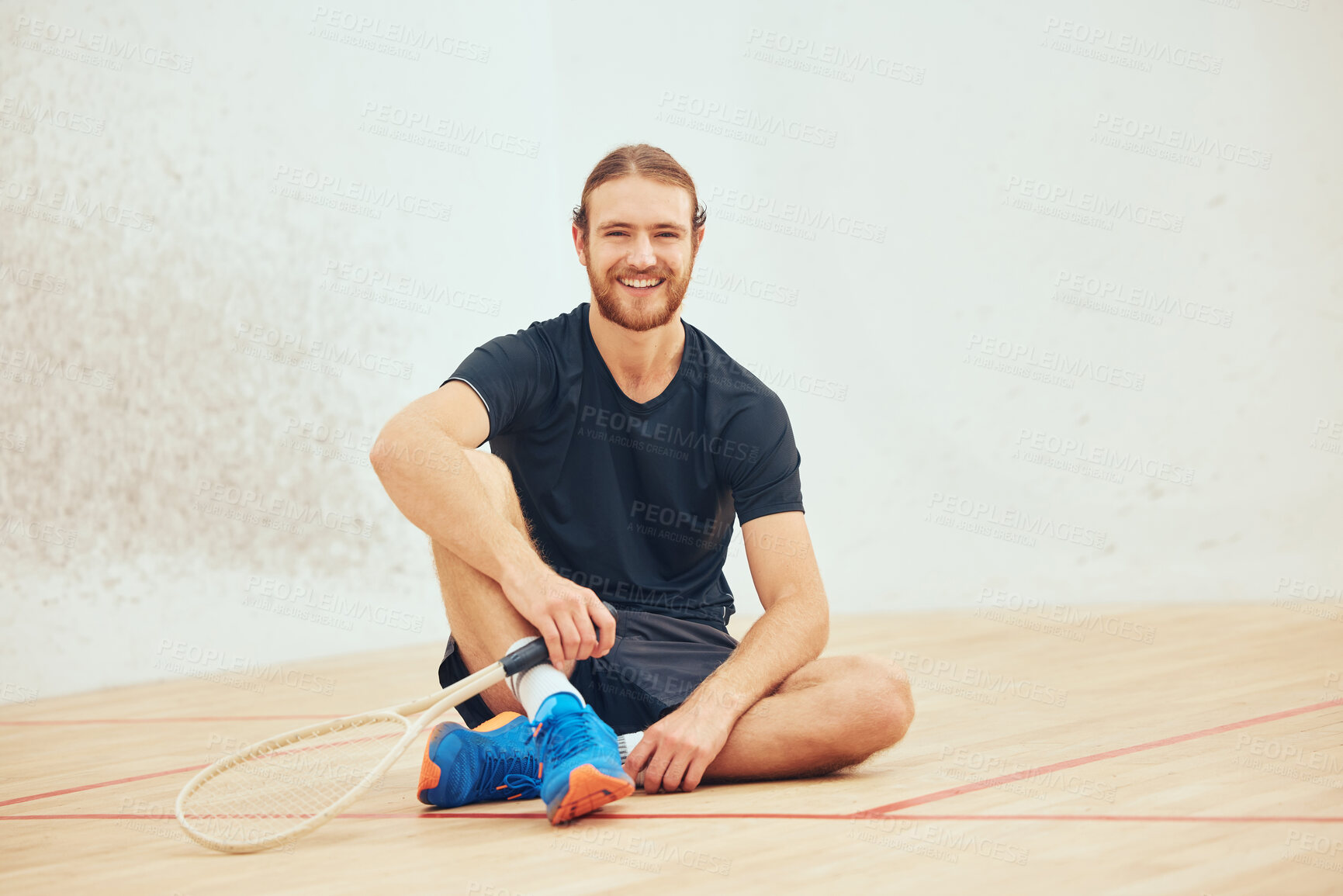 Buy stock photo Portrait, squash and man in gym for fitness, relax or rest on break on mockup space. Smile, sport and tired athlete with racket on wood floor at health club for body wellness with exercise equipment