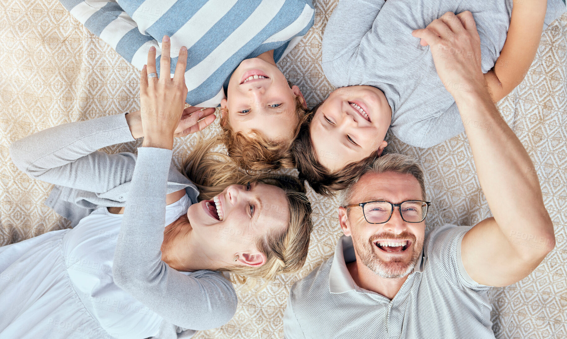 Buy stock photo Above, portrait and family with love, funny and tickle with happiness, smile and time together. Face, parents and mother with father, kids and fun with childhood, playful and joke with care in home