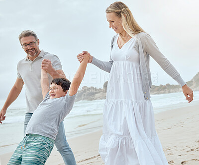 Buy stock photo Parents, boy and holding hands at beach with swing, fun and bonding with games on vacation in summer. Father, mother and child on holiday for connection, memory and playful with family in sunshine