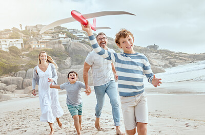 Buy stock photo Parents, children and airplane toys at beach with running, smile or bonding with love on vacation in summer. Dad, mom and kids on holiday with flight, game or playful with family in sunshine by ocean