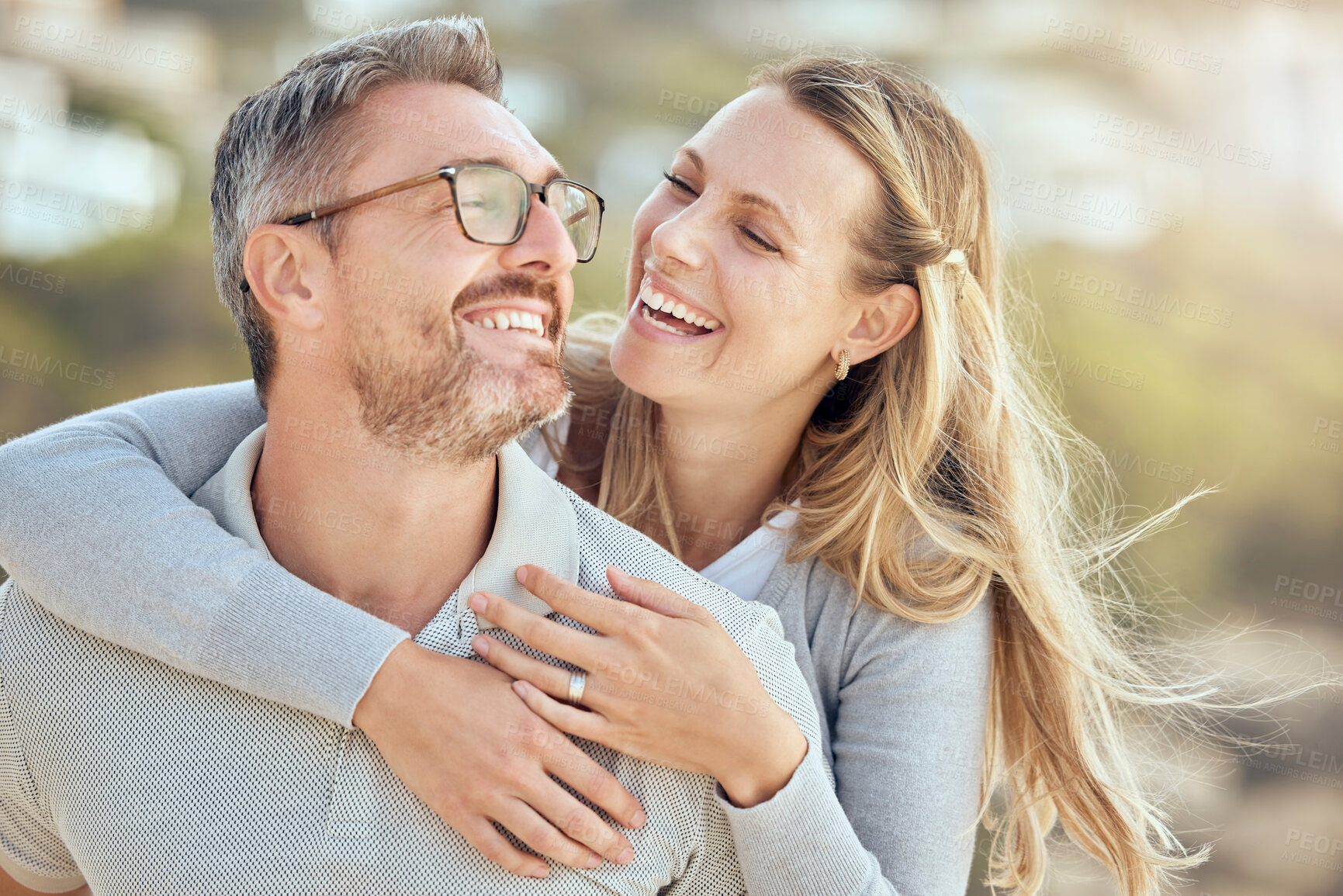 Buy stock photo Mature couple, smile and piggyback in nature for outdoor date, romantic time and bonding together. Happy, love and husband carry wife in park with marriage commitment, anniversary vacation and care