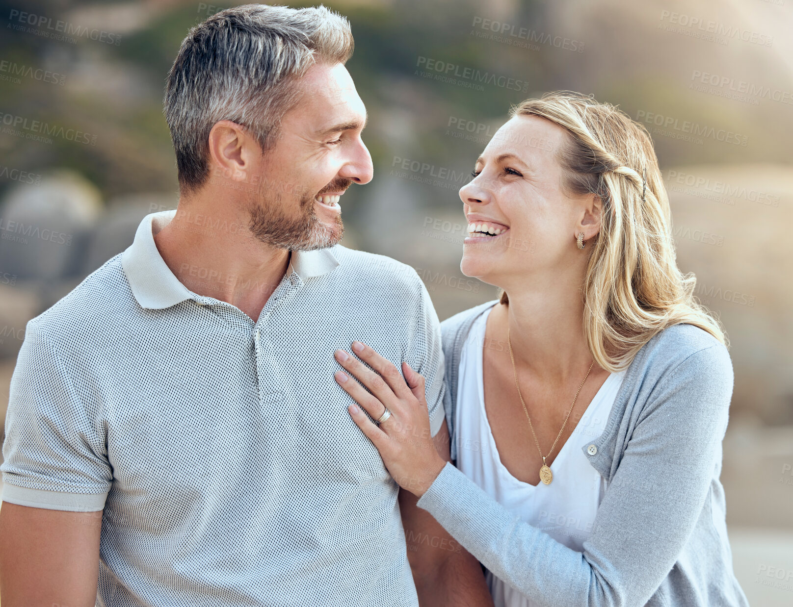 Buy stock photo Laughing, happy man and woman at beach for love, trust and care or support for relationship. Together, couple and smile in nature for date or travel, marriage and joke or humour for outdoor adventure