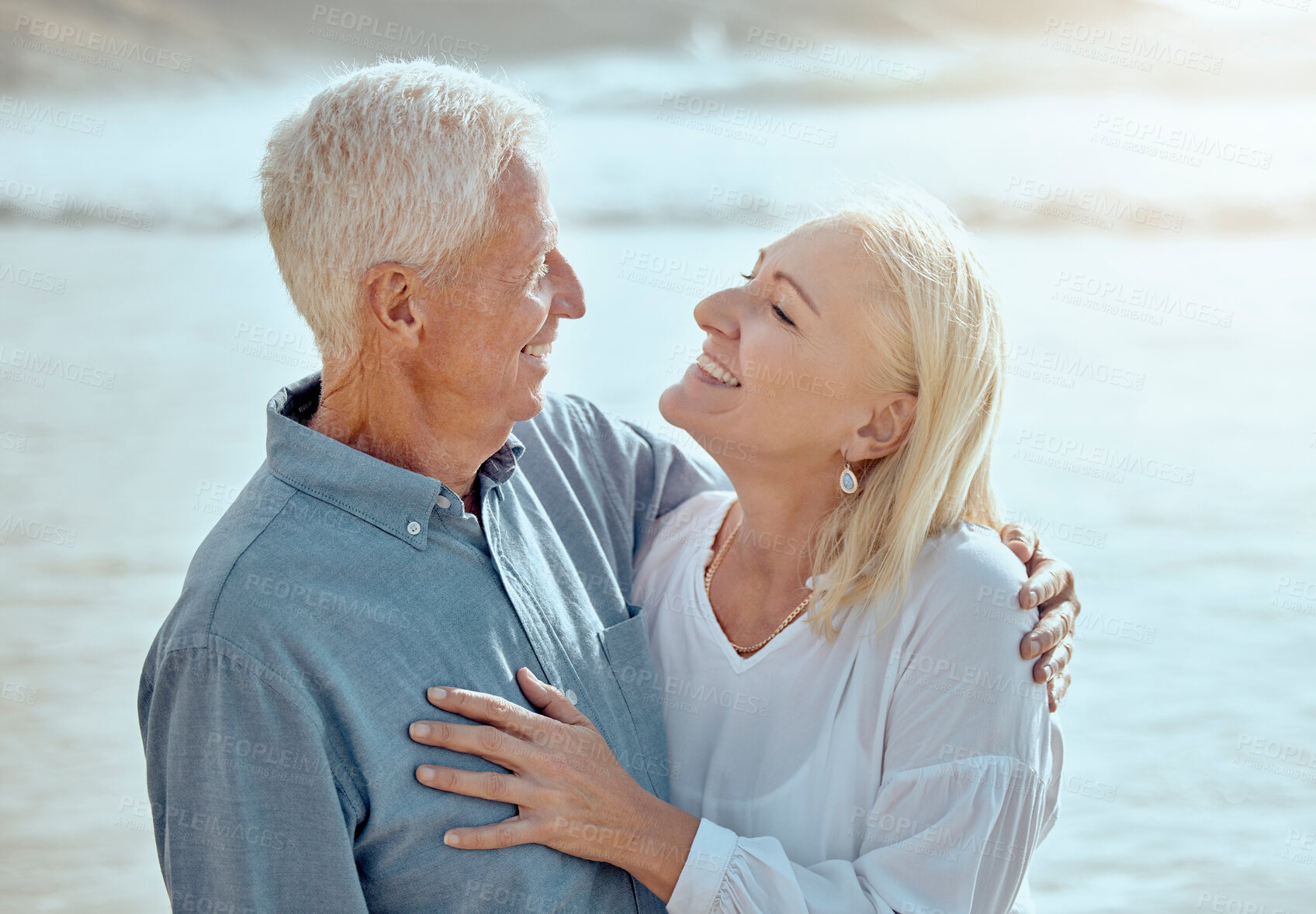 Buy stock photo Mature, couple and happy on beach with love on retirement vacation, romance and together with years of commitment. Man, woman and affection by ocean on summer holiday, trust and bonding with embrace.