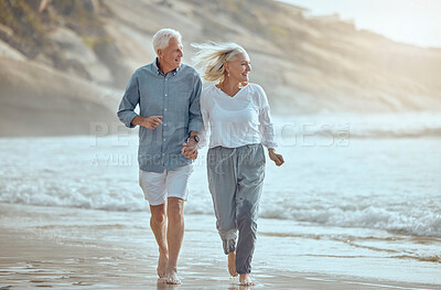 Buy stock photo Mature, couple and running on beach with love on retirement vacation, romance and together with fun or freedom. Man, woman and holding hands by ocean on holiday, happy and bonding with energy.