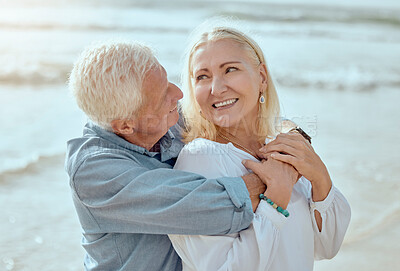 Buy stock photo Mature, couple and hug on beach with care on retirement vacation, romance and together with years of commitment. Man, woman and affection by ocean on summer holiday, love and bonding with embrace.