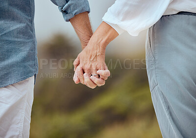 Buy stock photo Mature, couple and holding hands in outdoor with love, support and trust with commitment in relationship. People, walk and together in nature with romance or connection, respect and care for partner.