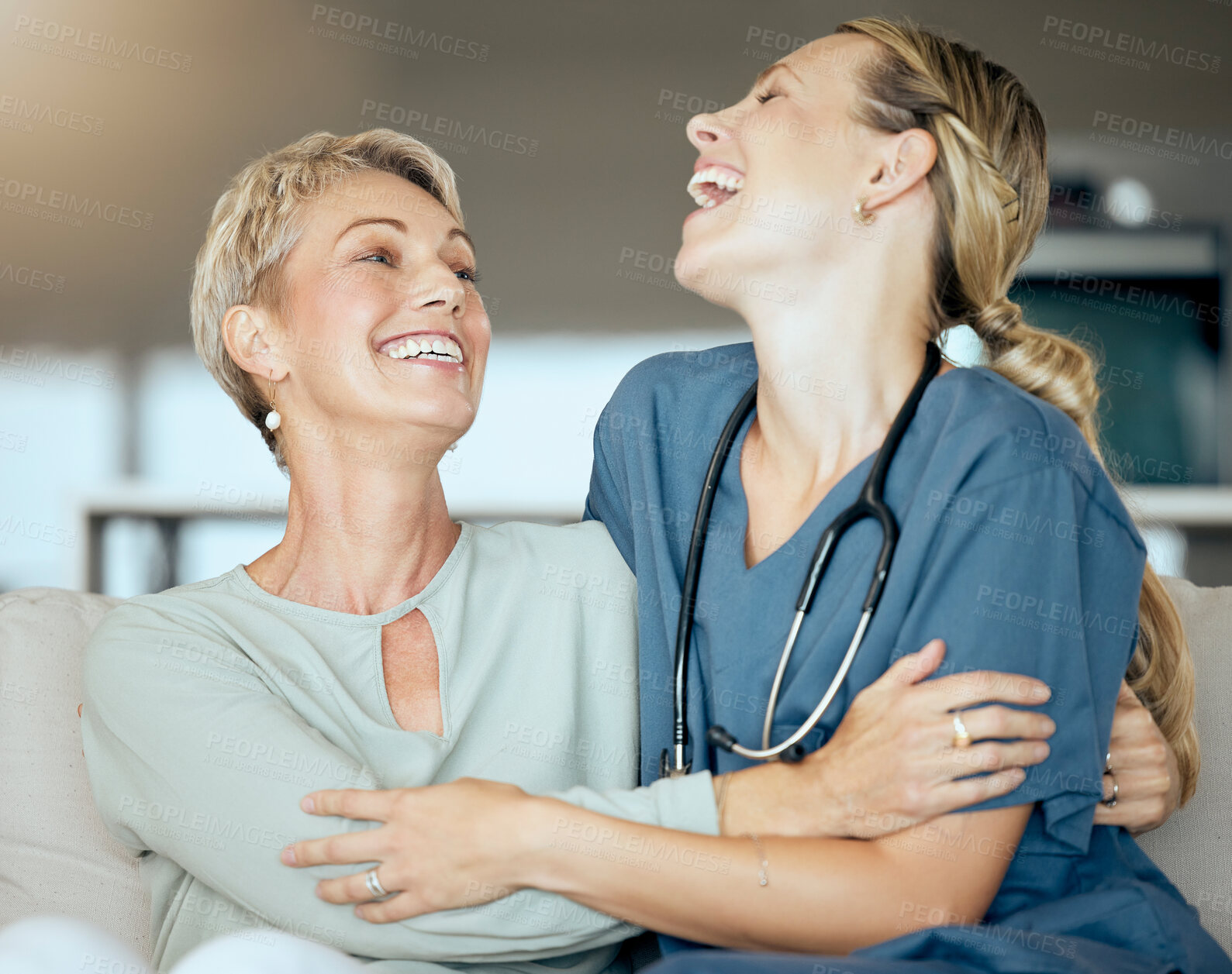 Buy stock photo Funny, laughing or visit with nurse and old woman on sofa in living room of retirement home for healthcare. Hug, medical or happy story with patient and caregiver embracing in apartment together