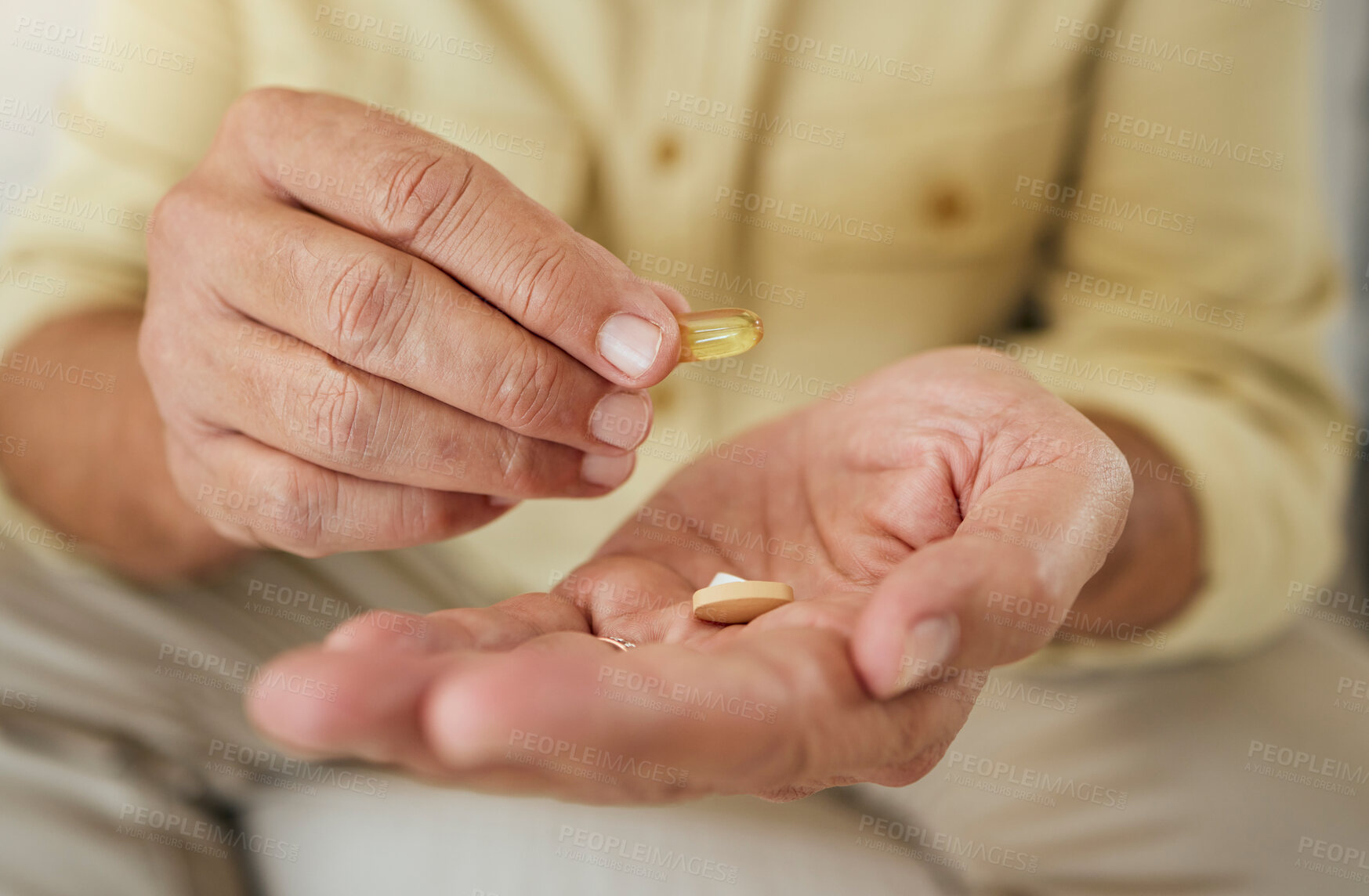 Buy stock photo Elderly man, hands and pills or treatment in house, illness management and prescription drugs or hypertension. Capsule, antibiotic and pharmaceutical product in retirement, patient and health routine