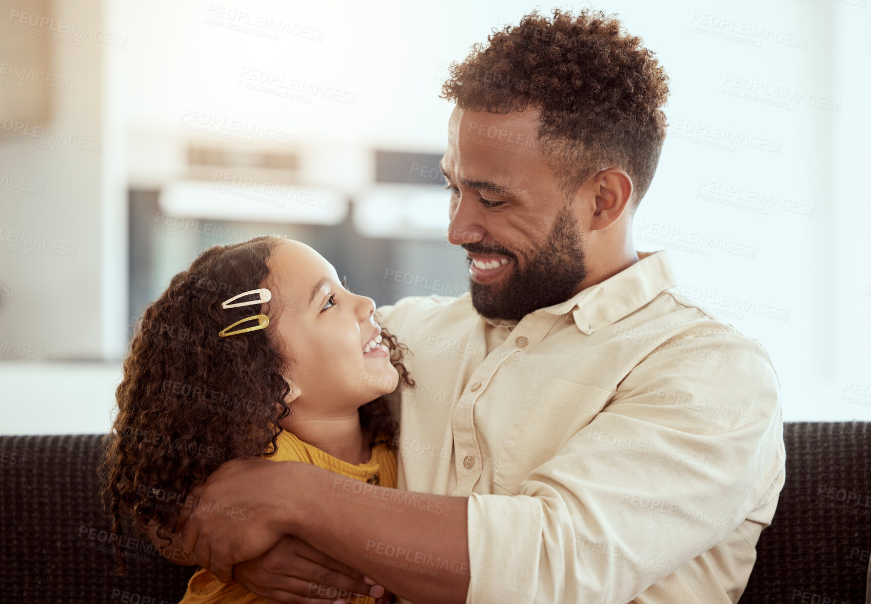 Buy stock photo Hugging, sofa and child with father for connection, care and love together in home with happiness. Smile, bonding and girl kid embracing dad for relax in living room on weekend at house in Colombia.