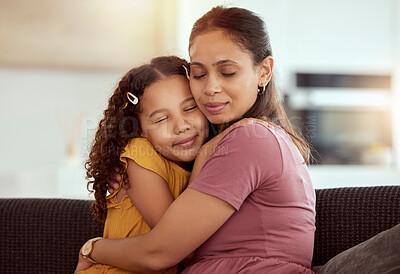 Buy stock photo Connection, sofa and child hug mother for love, care and bonding together in home. Smile, family and girl kid embracing single mom for support and relax in living room on weekend at house in Colombia