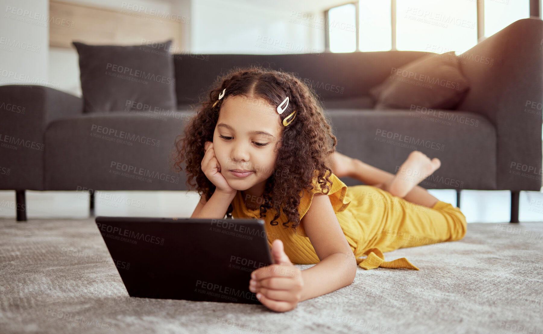 Buy stock photo Relax, bored and child with tablet in home living room for game, show or streaming cartoon on floor. Technology, girl or kid with internet addiction, thinking or reading story on education app online