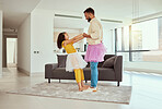 Full length mixed race single father dancing with adorable daughter in living room at home. Cute little hispanic girl wearing tutus with single parent and bonding in lounge. Man and child together